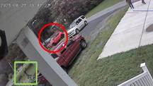 A red circle in the middle of a red circle in the middle of a red car parked in a parking lot